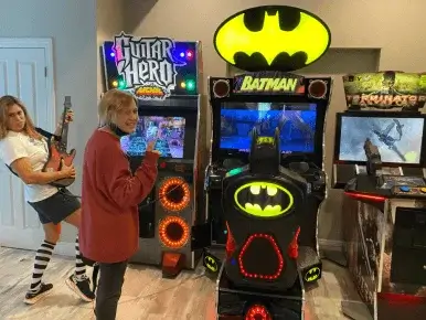 glow-in-the-dark neon bedroom with skeeball and Family Guy bowling arcade